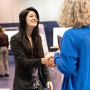 Makayla Rae Shank, left, a student at Penn State New Kensington, shakes hands with Jennifer Gilley, head librarian at the campus